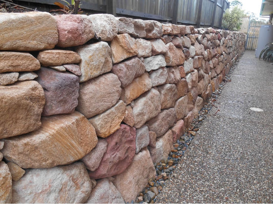Hand Placed Sandstone Retaining Wall Transformation in Arundel, QLD