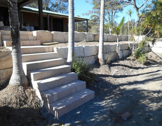 Enhancing a Pool Area with a Sandstone Boulder Wall in Yatala